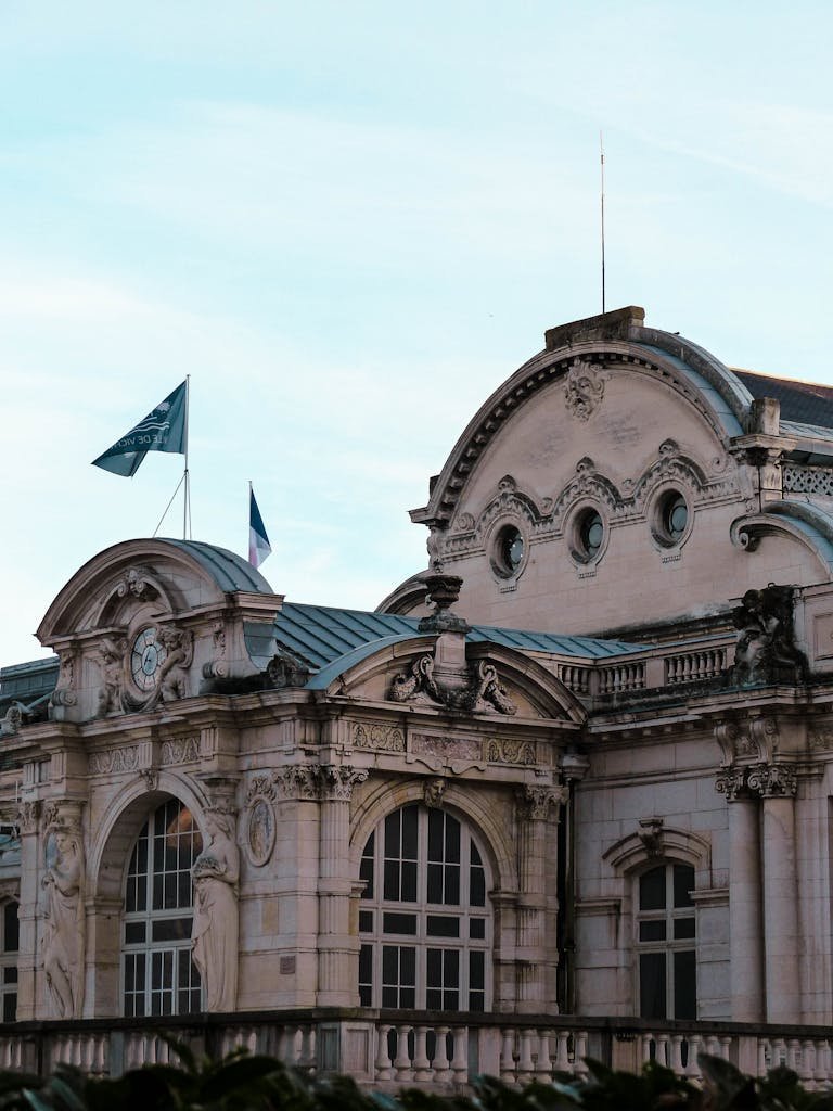 Close-up of the ornate facade of a historic building in Vichy, France, showcasing architectural details.