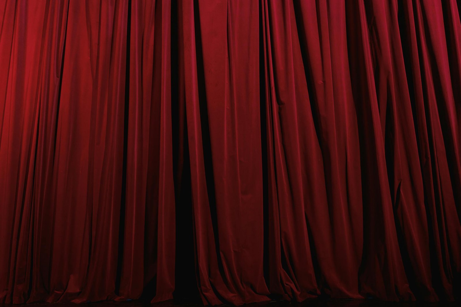 Rich red curtains with elegant drapery, perfect for theater or luxury decor themes.